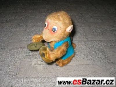stará hračka plechová opice opička na klíček